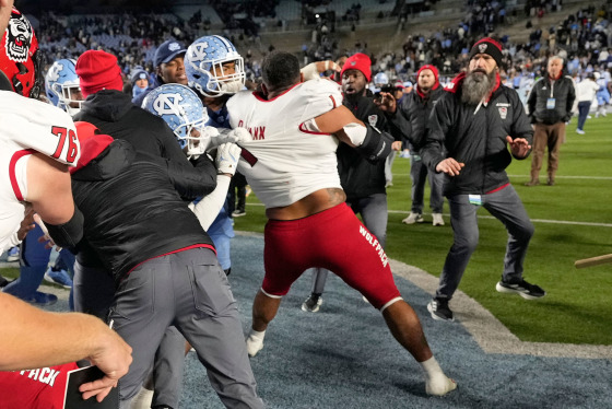 North Carolina Tar Heels players and North Carolina State Wolfpack players fight