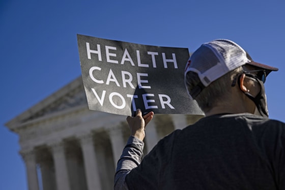 A supporter of the Affordable Care Act demonstrates in front of the Supreme Court on Nov. 10, 2020.