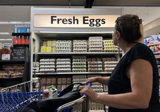 A shopper walks by a display of fresh eggs at a grocery store in San Anselmo, Calif.