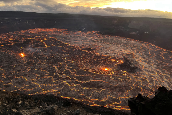 A lake of active lava in the summit caldera glows as the sun rises during a new eruption at Kilauea volcano in Hawaii, on Dec. 23, 2024.