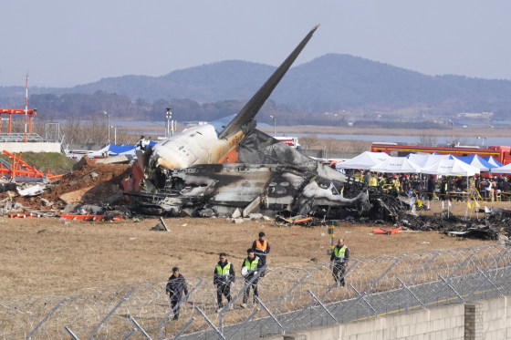 Image: Firefighters and rescue team members work near the wreckage of a passenger plane at Muan International Airport in South Korea.