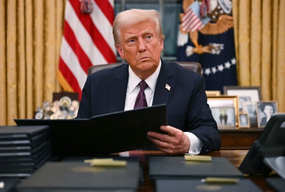 President Donald Trump signs an executive order for pardons  at the White House on Jan. 20, 2025. 