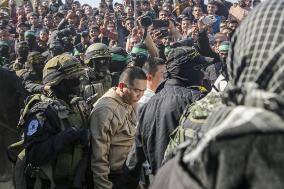 Two Thai captives being escorted.