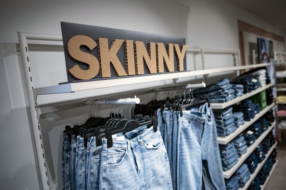Various skinny jeans on display in the clothing store