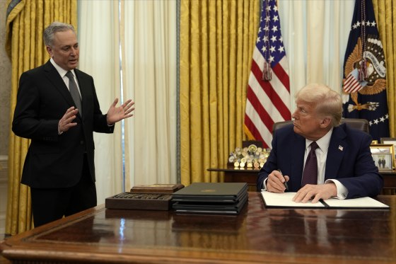 President Donald Trump listens to White House adviser David Sacks as he signs an executive order regarding cryptocurrency in the Oval Office of the White House, Thursday, Jan. 23, 2025, in Washington.