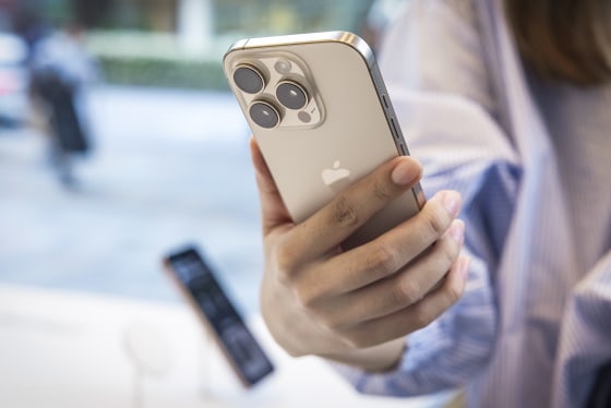 A customer holds the new Apple iPhone 16 Pro in her hand