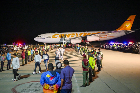 Venezuelan migrants disembark planes.
