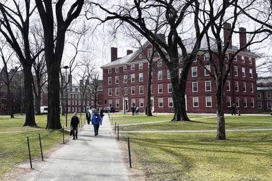 People walk through the campus of Harvard University in Cambridge, Mass., Tuesday, March 18, 2025.