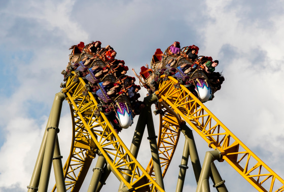 Attendees ride a rollercoaster.