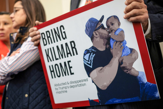 A member of the Congressional Hispanic Caucus holds a picture of Kilmar Abrego Garcia.