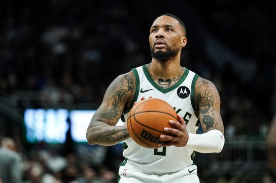Damian Lillard holds a basketball on the court