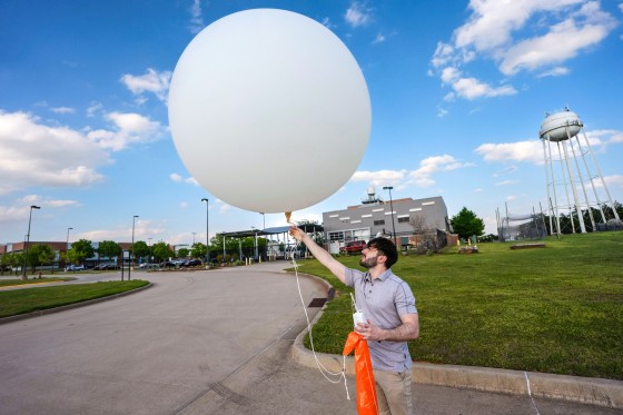 Phillip Ware, a meteorologist at the Norman office of the National Weather Service, launches a weather balloon to launch