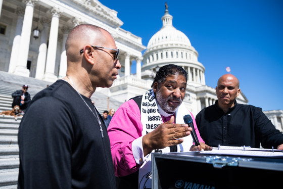 From left, Hakeem Jeffries Rev. Dr. William Barber, and Cory Booker outside of the U.S. Capitol steps