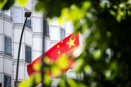 A Chinese flag flies in front of the Chinese embassy building