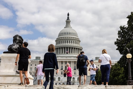People walk past the U.S. Capitol building