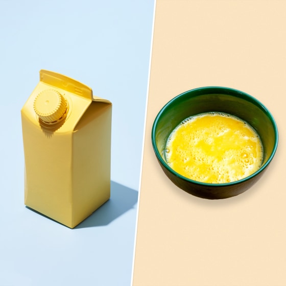 Yellow Small carton On Blue Background/Raw beaten eggs in a ceramic bowl