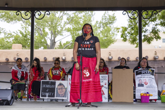 Kimberly Wahpepah, a member of the Navajo Nation, speaking on stage at a rally in Santa Fe