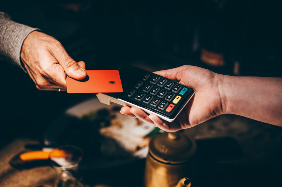 Man pays with a card in a cafe.