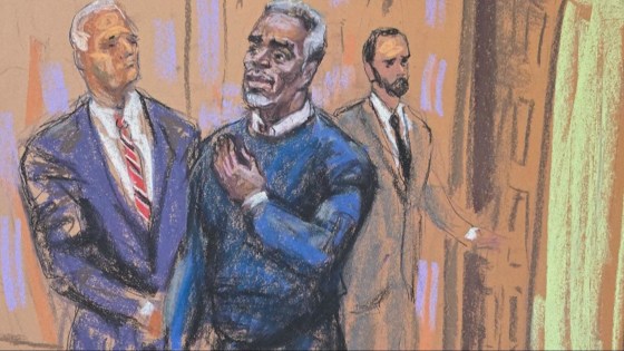Sean "Diddy" Combs puts his hand on his heart as he enters the courtroom for jury selection at the start of his sex trafficking trial in New York on May 6, 2025.