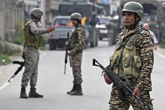 Indian security personnel stand guard in Wuyan