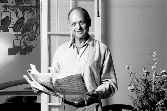 Portrait Of Charles Strouse holding music sheets.