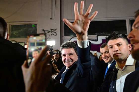 Bucharest Mayor Nicusor Dan salutes his supporters as he exit his campaign headquarters in Bucharest 
