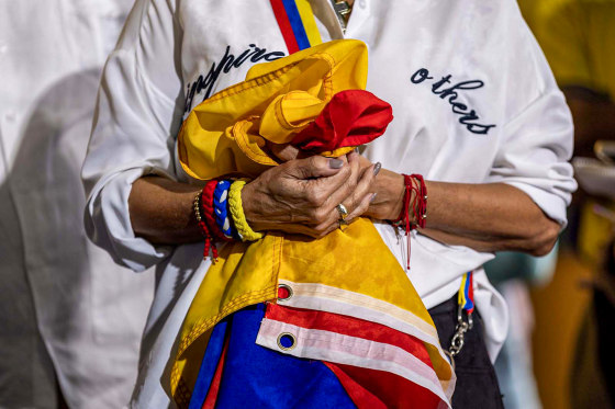 A woman holds a Venezuelan flag.