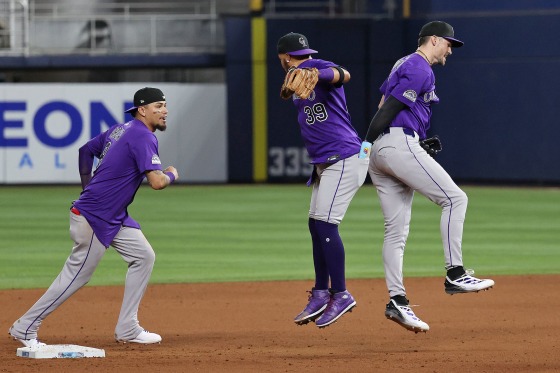 Thairo Estrada, center, and Brenton Doyle, right, of the Colorado Rockies jump in the air to celebrate a win over the Miami Marlins on June 3, 2025 in Miami.