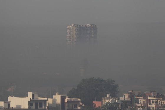 A residential building engulfed in smog in the morning in the Faridabad district of India's Haryana state on April 26.