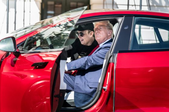 Elon Musk and President Donald Trump inside of a Tesla model S vehicle parked outside of the White House