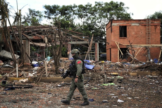 A police officer patrols a damaged area