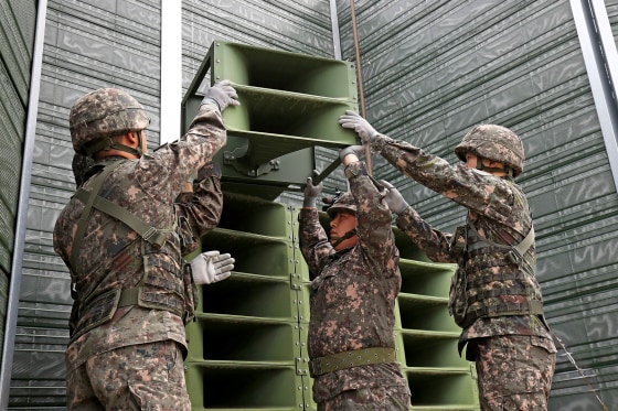 South Korean soldiers take down a propaganda loudspeakers