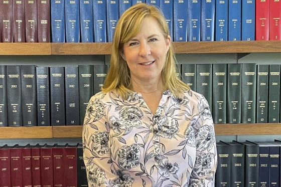 State Rep. Melissa Hortman stands in front of Minnesota law books in her office in St. Paul in 2023. 
