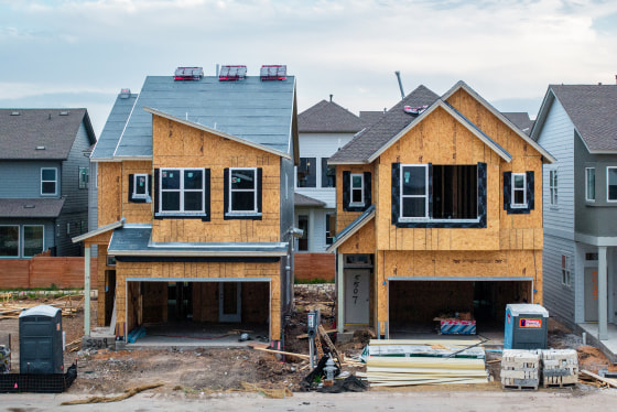 An aerial view of two houses side by side undergoing construction