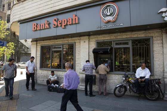 Customers use an automated teller machine (ATM) outside a Bank Sepah bank