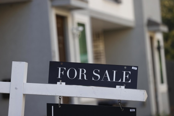 A "For Sale" sign outside a house in Houston.