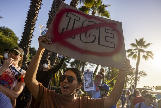 A person holds a sign in a protest.
