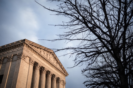 The exterior of the Supreme Court building on the left, a tree is seen on the right