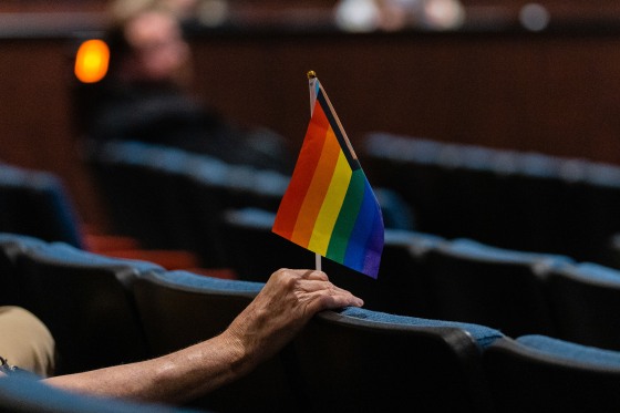 A person holds an inclusive pride flag during a Fairfax County School Board meeting after a rally in support of inclusive Family Life Education at Luther Jackson Middle School in Falls Church, Va. on July 14, 2022.