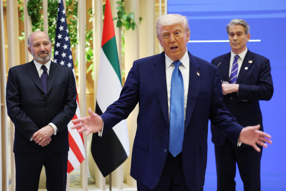 President Donald Trump speaking as Secretary of Commerce Howard Lutnick, left, and  Secretary of the Treasury Scott Bessent stand next to him.