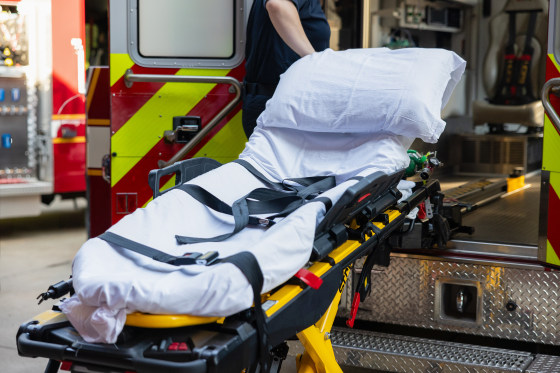 An empty stretcher in an ambulance.