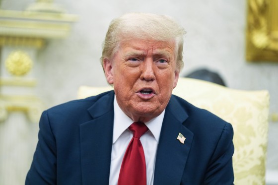 Donald Trump speaks while seated in the Oval Office