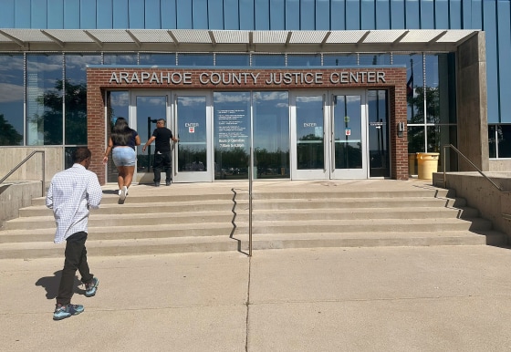 People enter the Arapahoe County Justice Center in Centennial, Colo., on Monday.