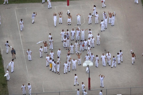 Migrant detainees react as a helicopter passes overhead at Krome Detention Center on July 4, 2025 in Miami, Fla.