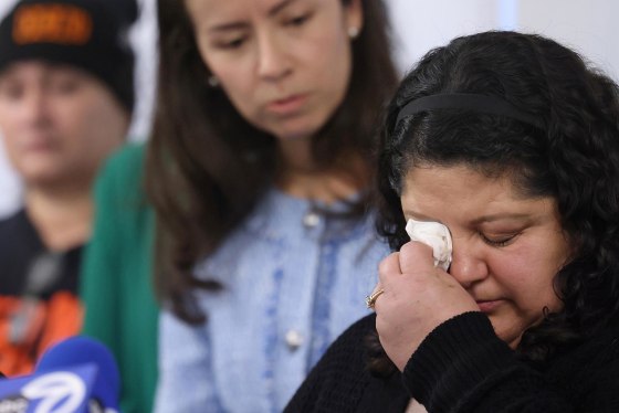 Abel Orozco's wife, Yolanda Orozco, wipes tears as she speaks during a news conference