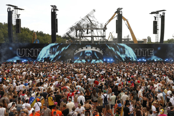 A crowd of people watching a performance at Tomorrowland music festival.