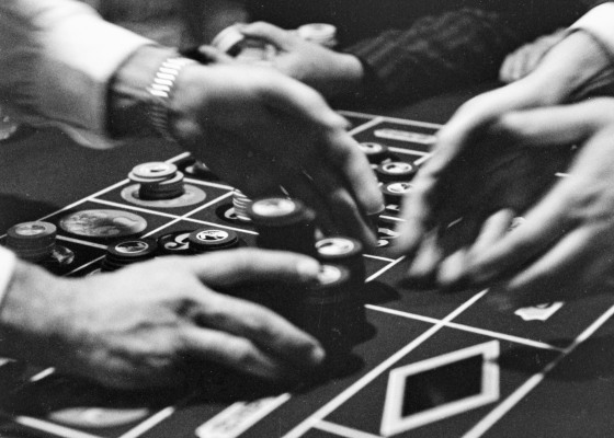 A croupier hands over a gambler's winning chips on the roulette table in Las Vegas