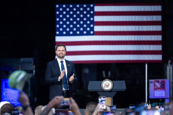 JD Vance smiling as he arrives to deliver remarks.