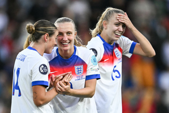 From left, Grace Clinton, Agnes Beever-Jones, and Esme Morgan celebrate on the field