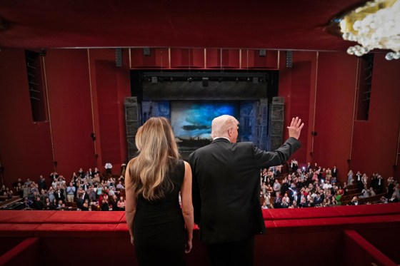 President Donald Trump and first lady Melania Trump wave from balcony at the John F. Kennedy Center for the Performing Arts